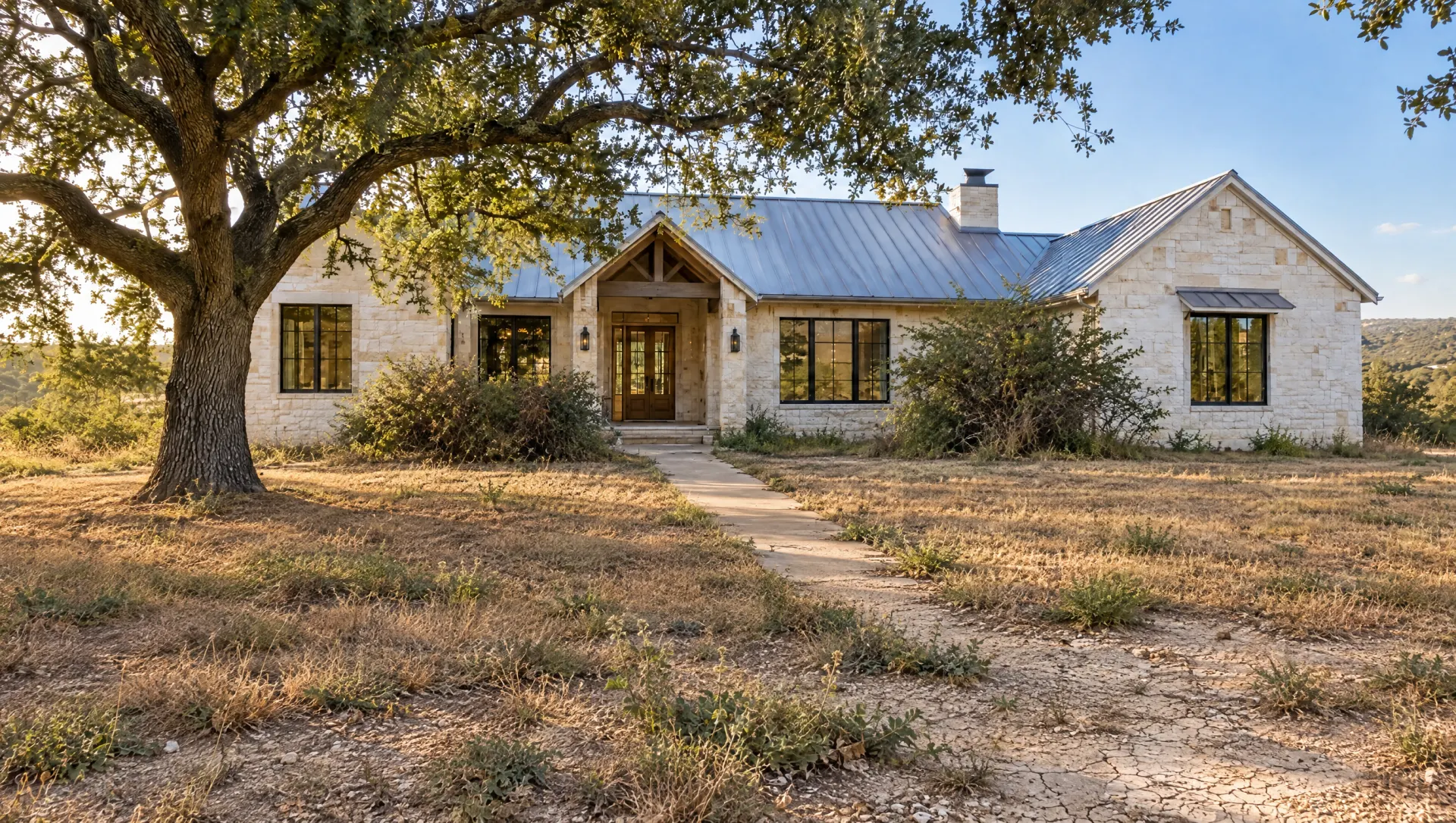 Before: a drought-killed front lawn of brown St. Augustine and bare caliche in front of a limestone ranch house