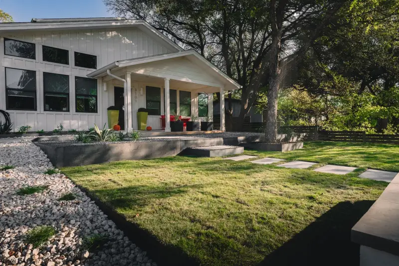 White bungalow with new lawn, steppers and steel edging